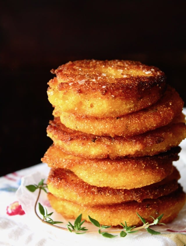 stack of hot water cornbread patties with fresh thyme