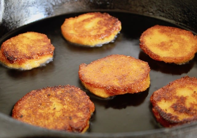 golden cornmeal patties in skillet