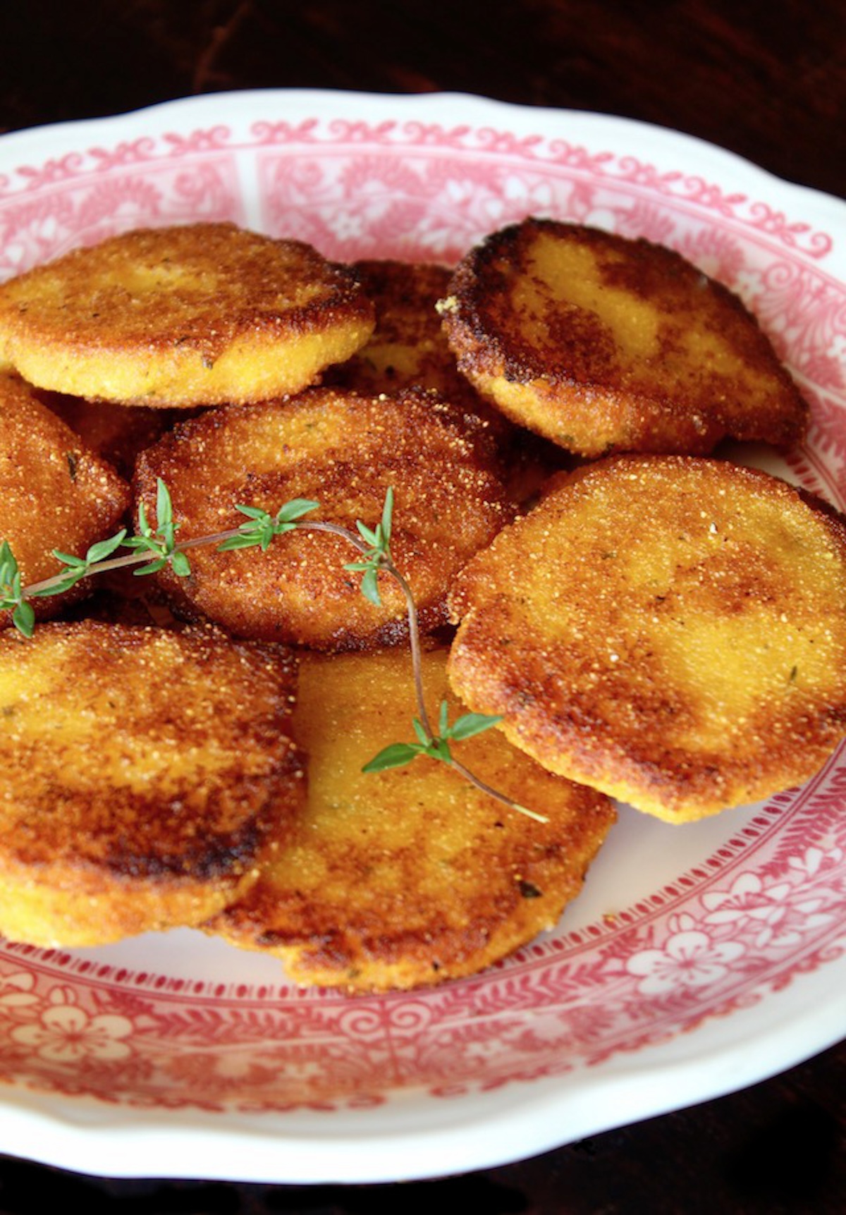Hot-Water-Cornbread-Recipe red-rimmed plate with several golden brown hot water cornbread patties