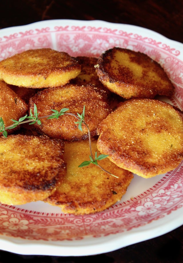 red-rimmed plate with several golden brown hot water cornbread patties