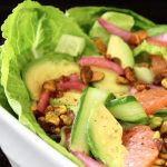 Close up of Cucumber Avocado Salad in white dish.