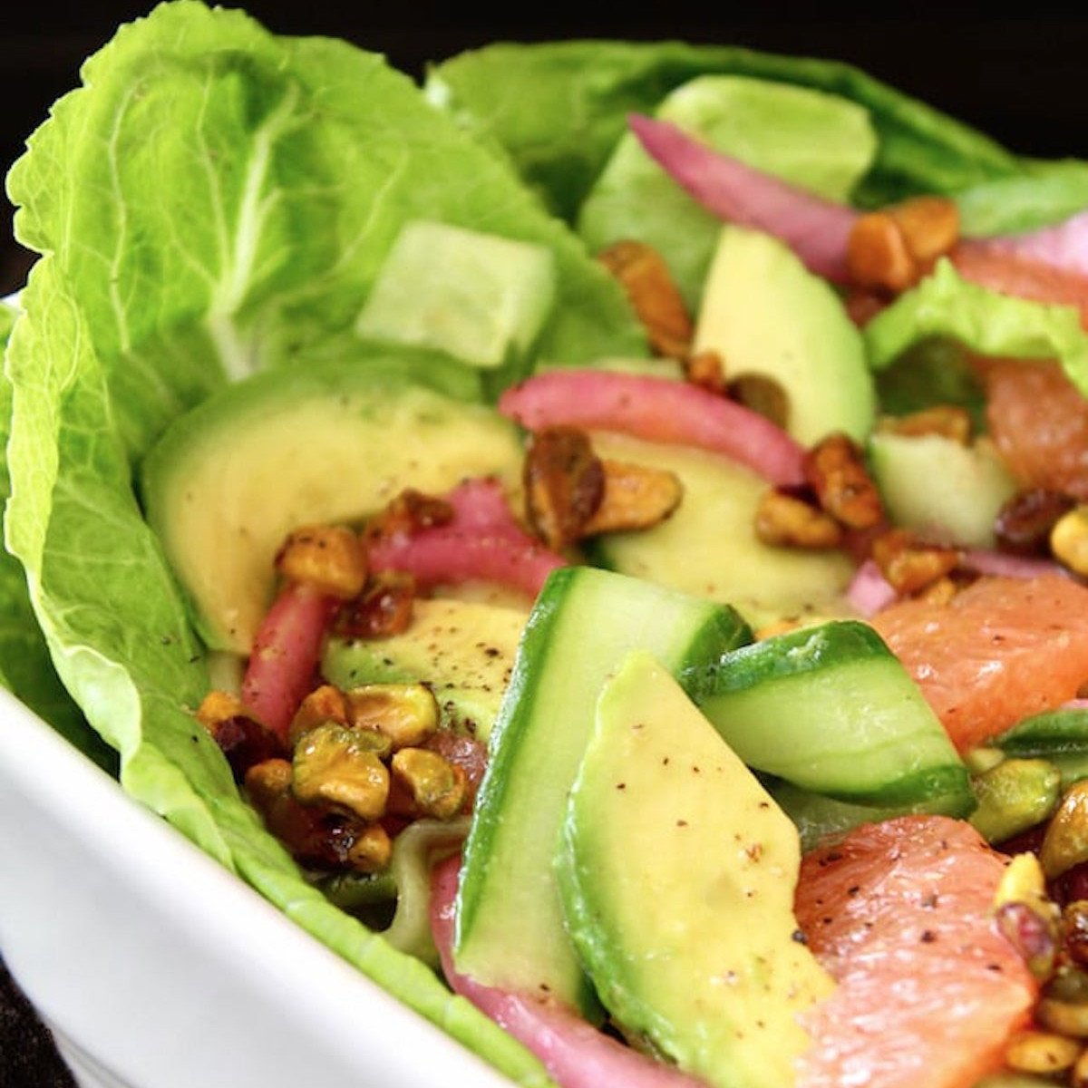 Close up of Cucumber Avocado Salad in white dish.