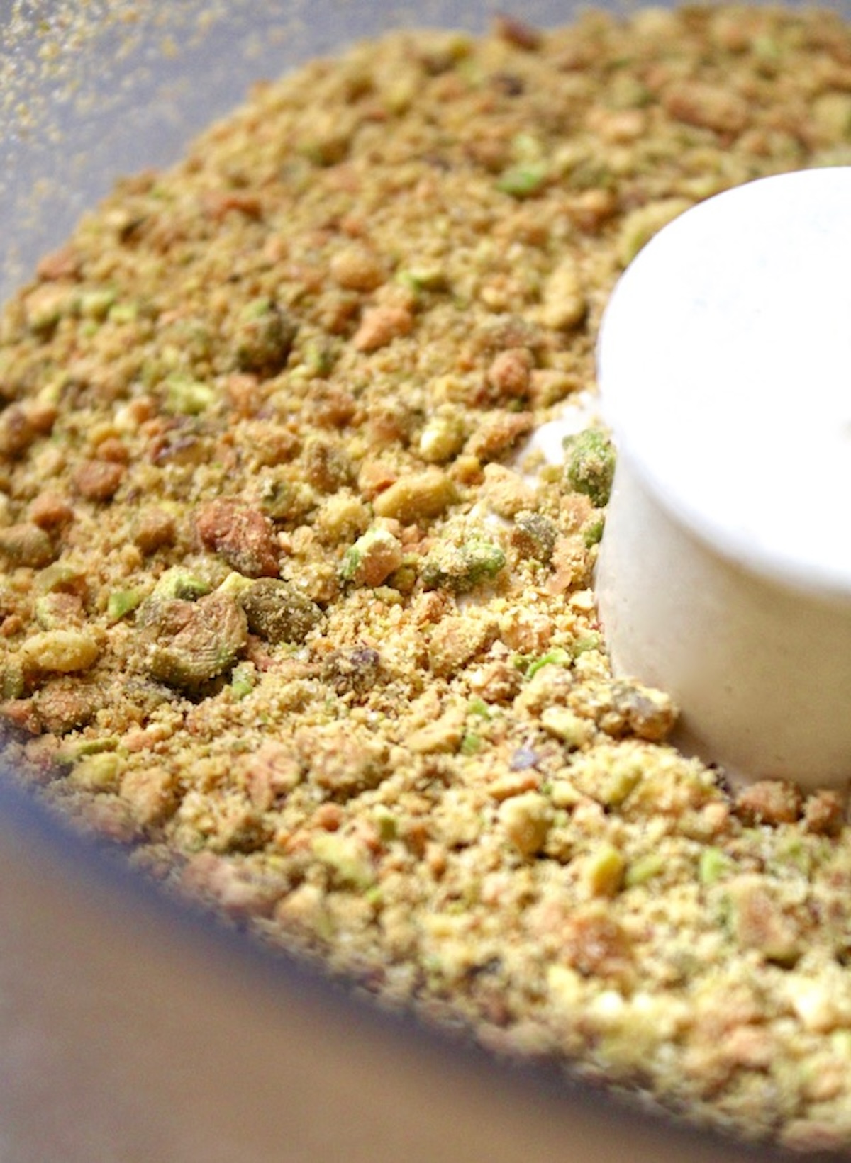 Chocolate-Tart-with-Pistachio-Crust Food processor bowl full with ground pistachios.