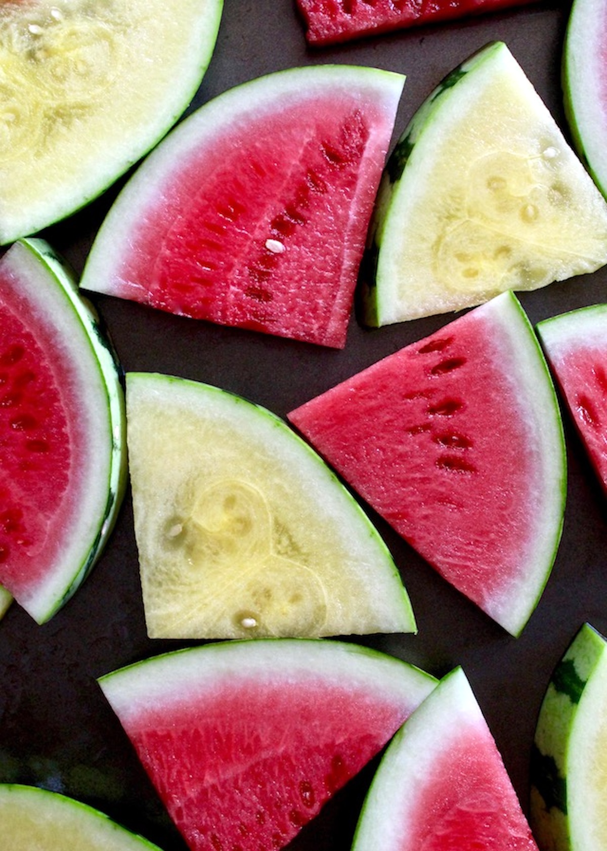 Lime-Chile-Grilled-Watermelon Slices of red and yellow watermelon on a sheet pan.