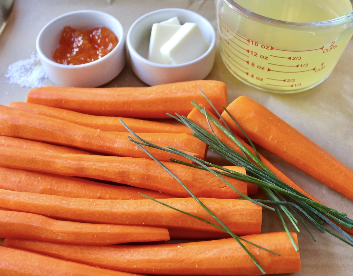 Sheet pan with about 2 pounds of peeled carrots, a few chives, 2 cups chicken stock and two small white ramekins- one with butter and one with apricot jam.