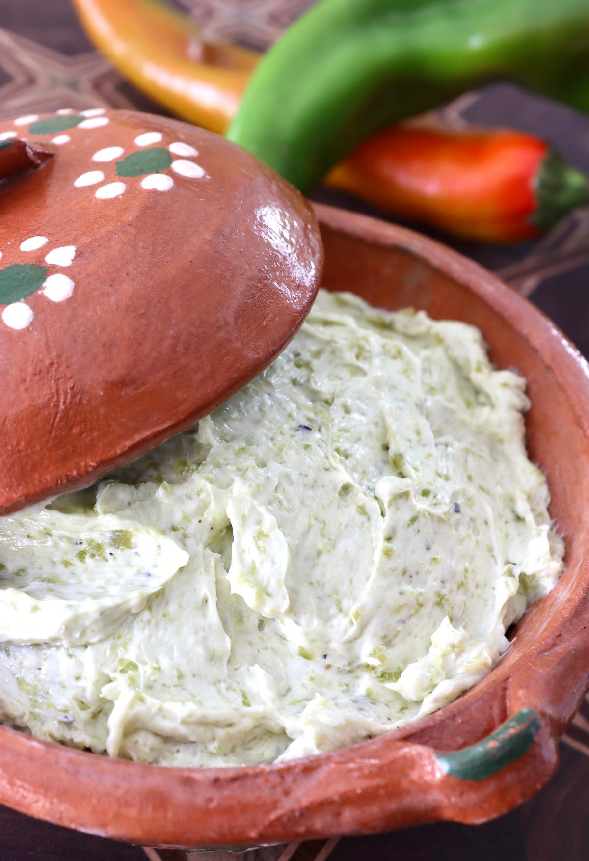Close up of Hatch chile butter in a terra cotta bowl.