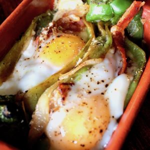 Two Roasted stuffed Hatch Chiles with Bacon and Eggs.