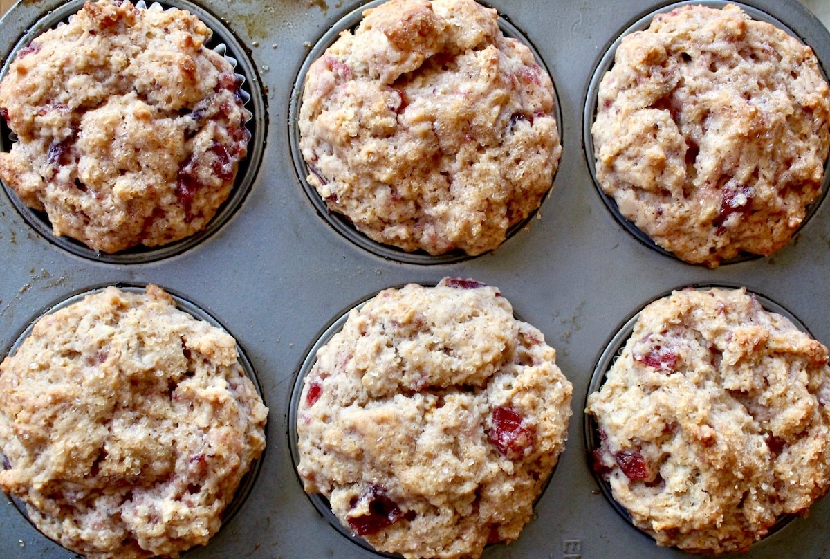 Baked leftover cranberry sauce muffins in muffin pan.