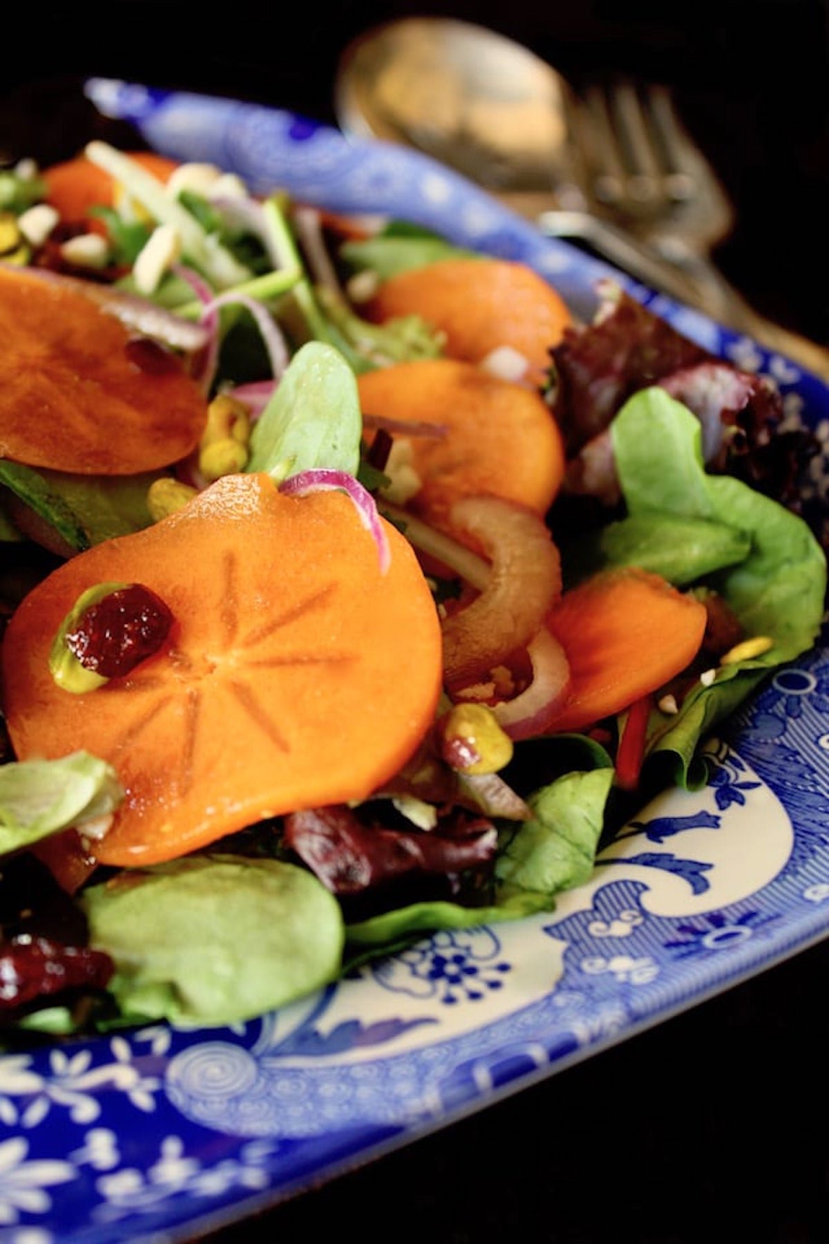 Persimmon salad on blue and white china platter