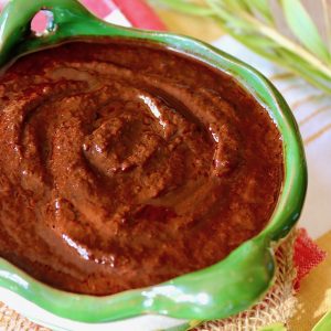 Rich and creamy Ancho enchilada sauce in a green bowl.