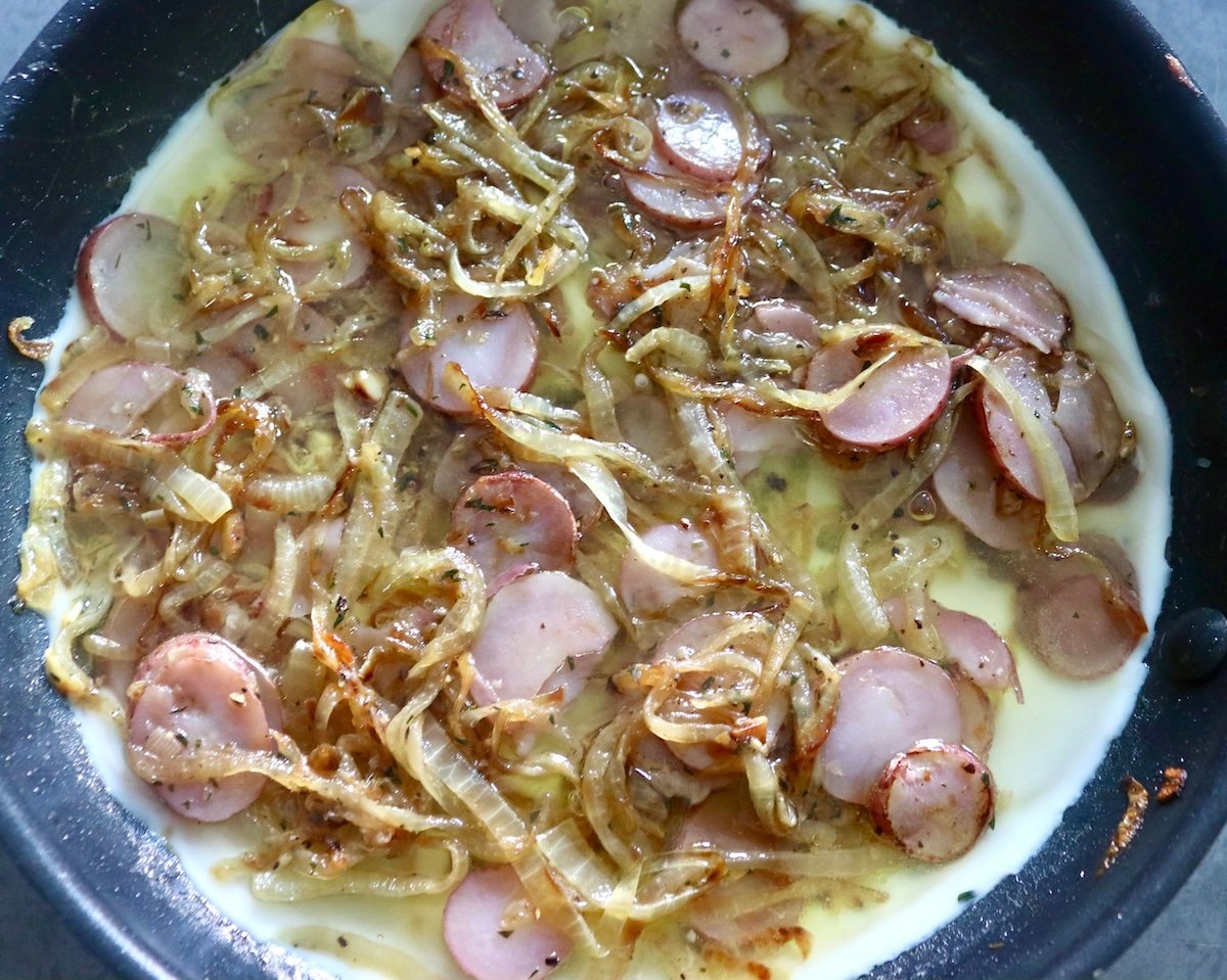 Partially cooked egg white frittata wiht pink potato slices.