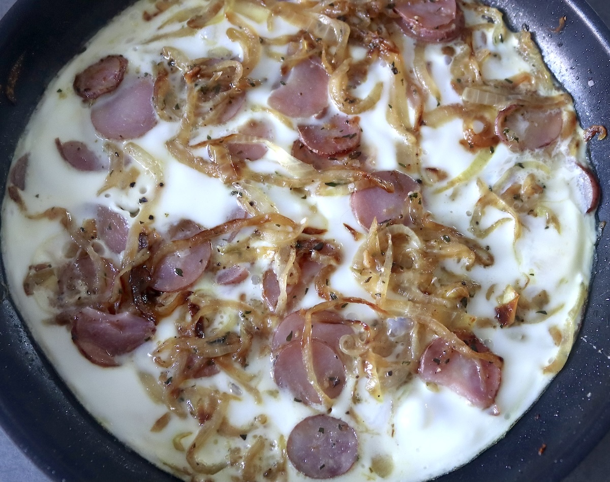 Cooked egg white frittata wihte pink potato slices.