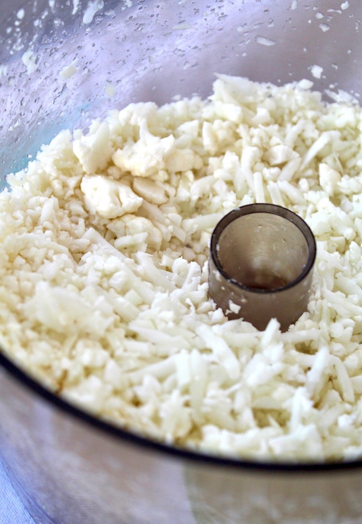 Riced cauliflower in a food processor.