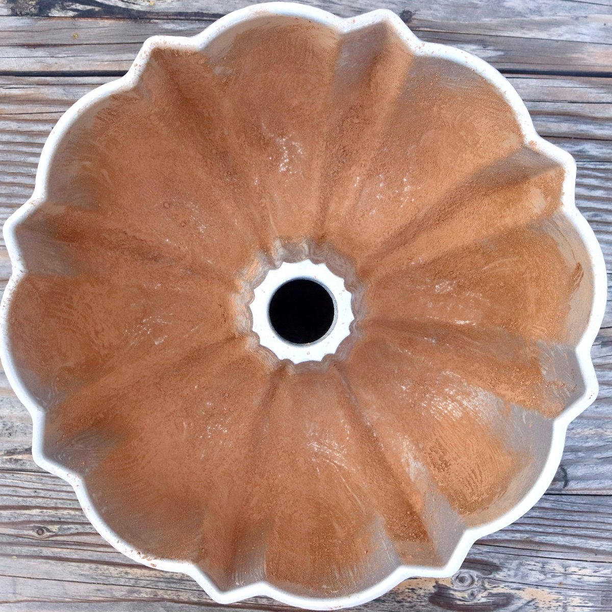 Bundt cake pan lined with butter and cocoa powder.