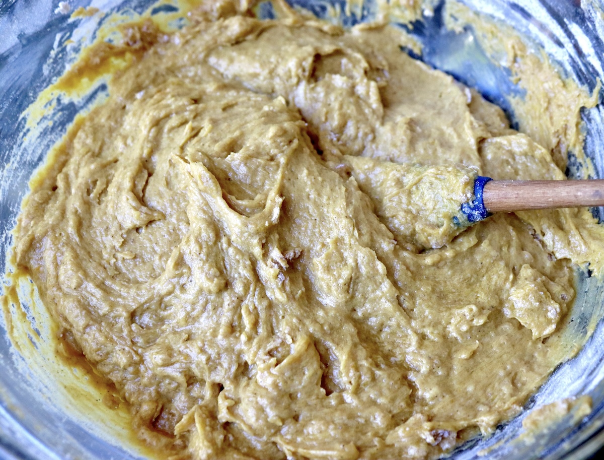 Pumpkin-Coffee-Cake-with-Streusel-and-Caramel Cake batter for pumpkin coffee cake with a blue rubber spatula.