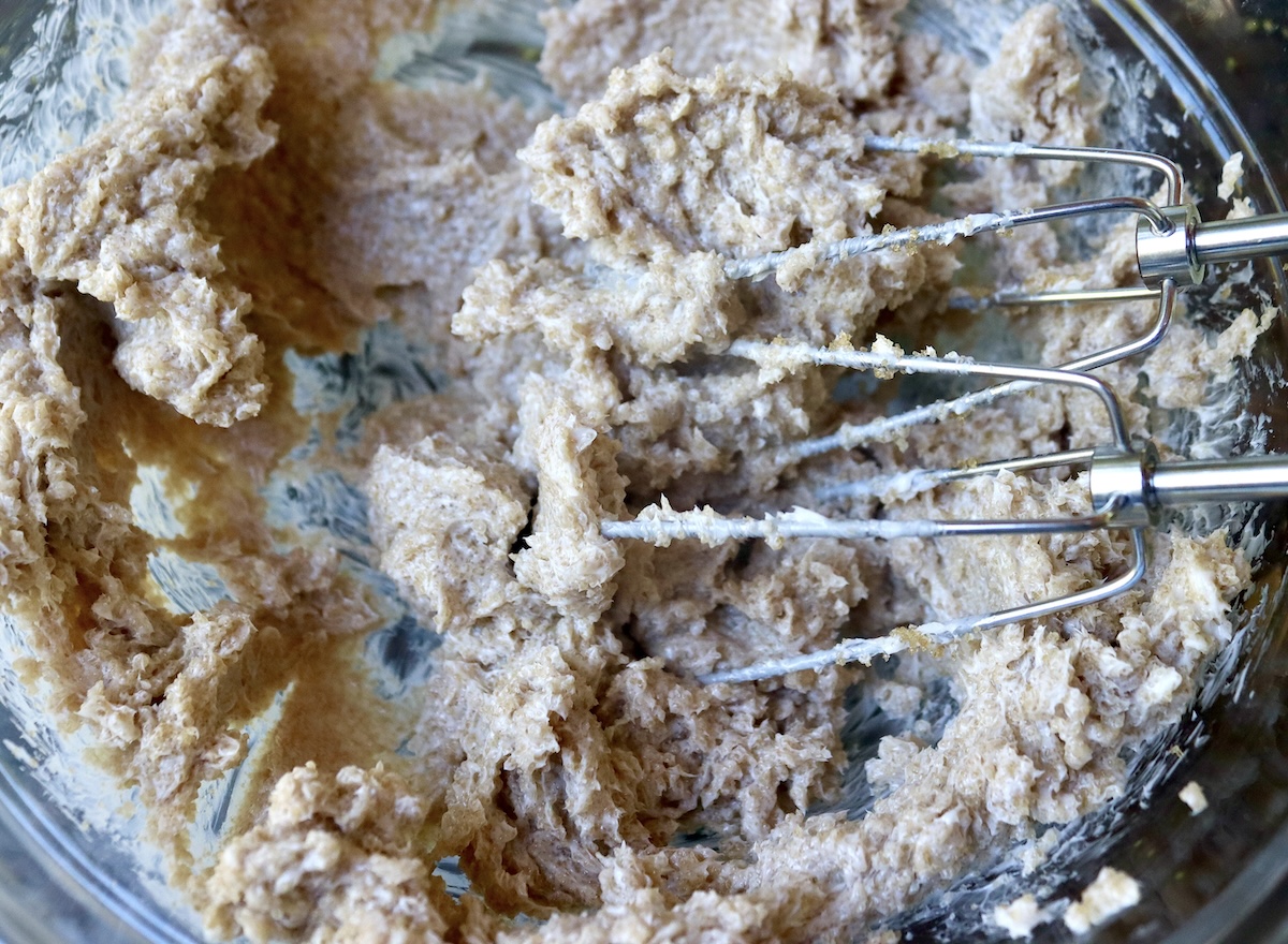 Pumpkin-Coffee-Cake-with-Streusel-and-Caramel Butter and brown sugar mixed with electric beaters in a glass bowl.
