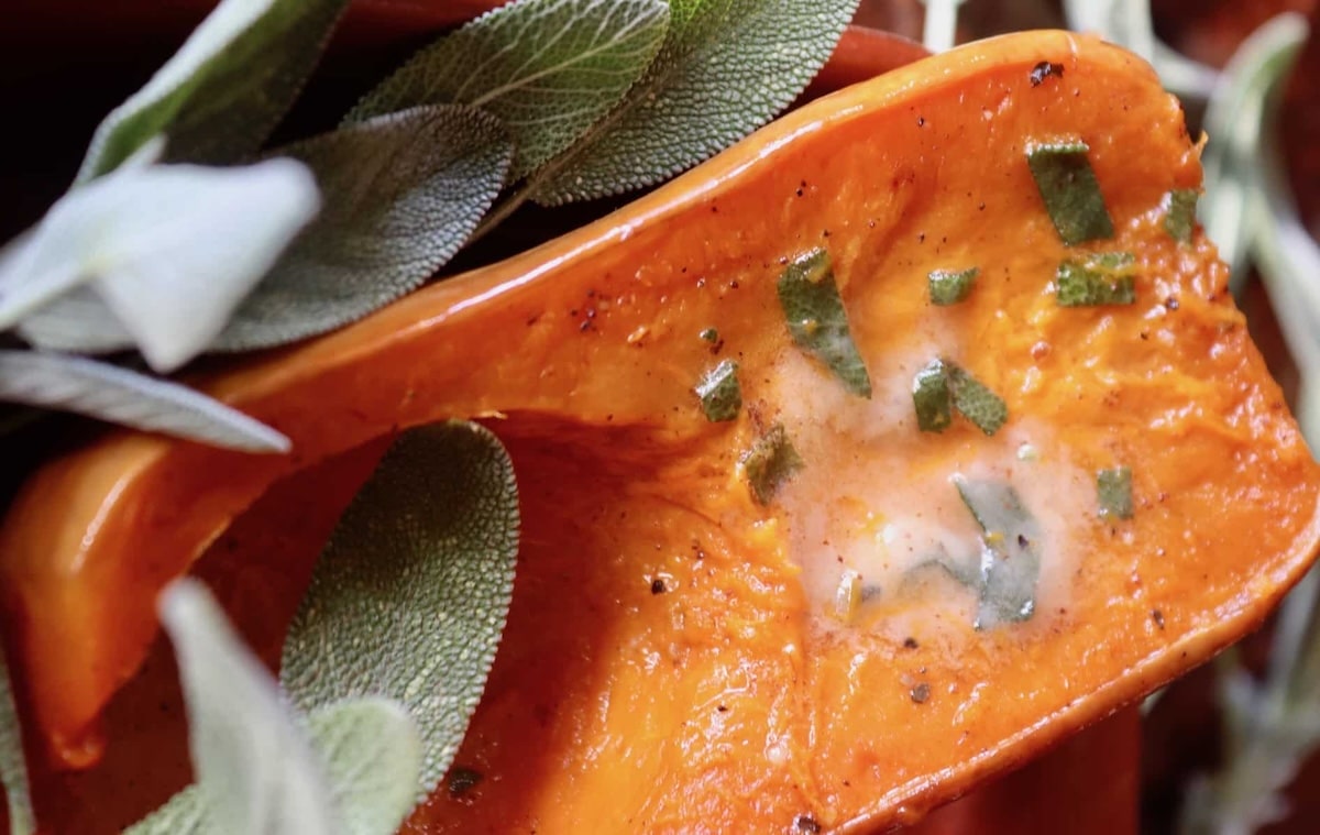 Brown-Sage-Butter Small butternut squash with melted brown sage butter over it.