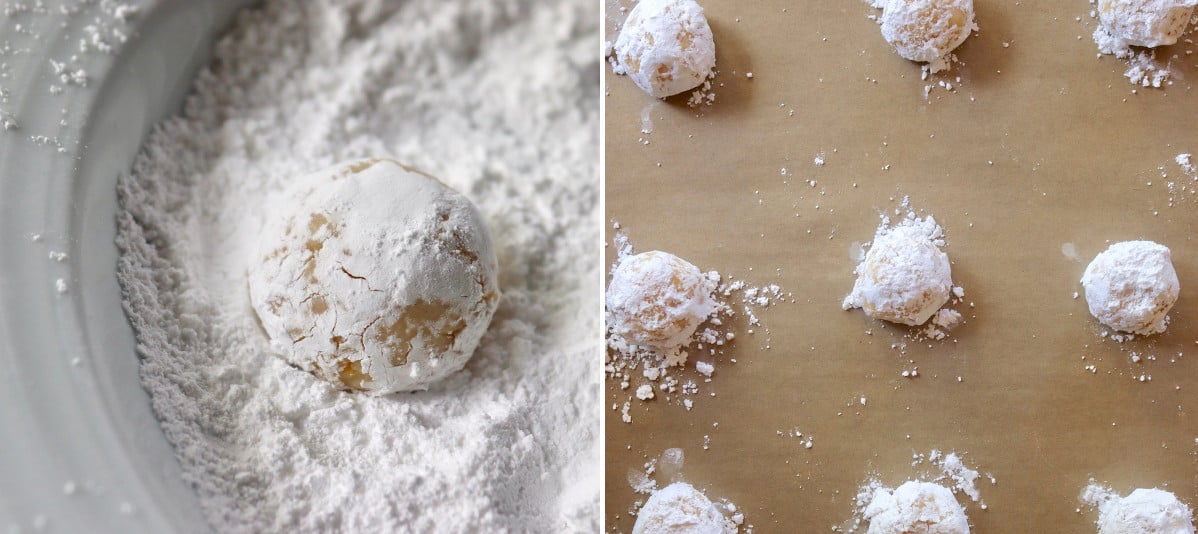Bowl with powdered sugar and a ball of cookie dough and a few rolled in the sugar on a baking sheet with parchment.