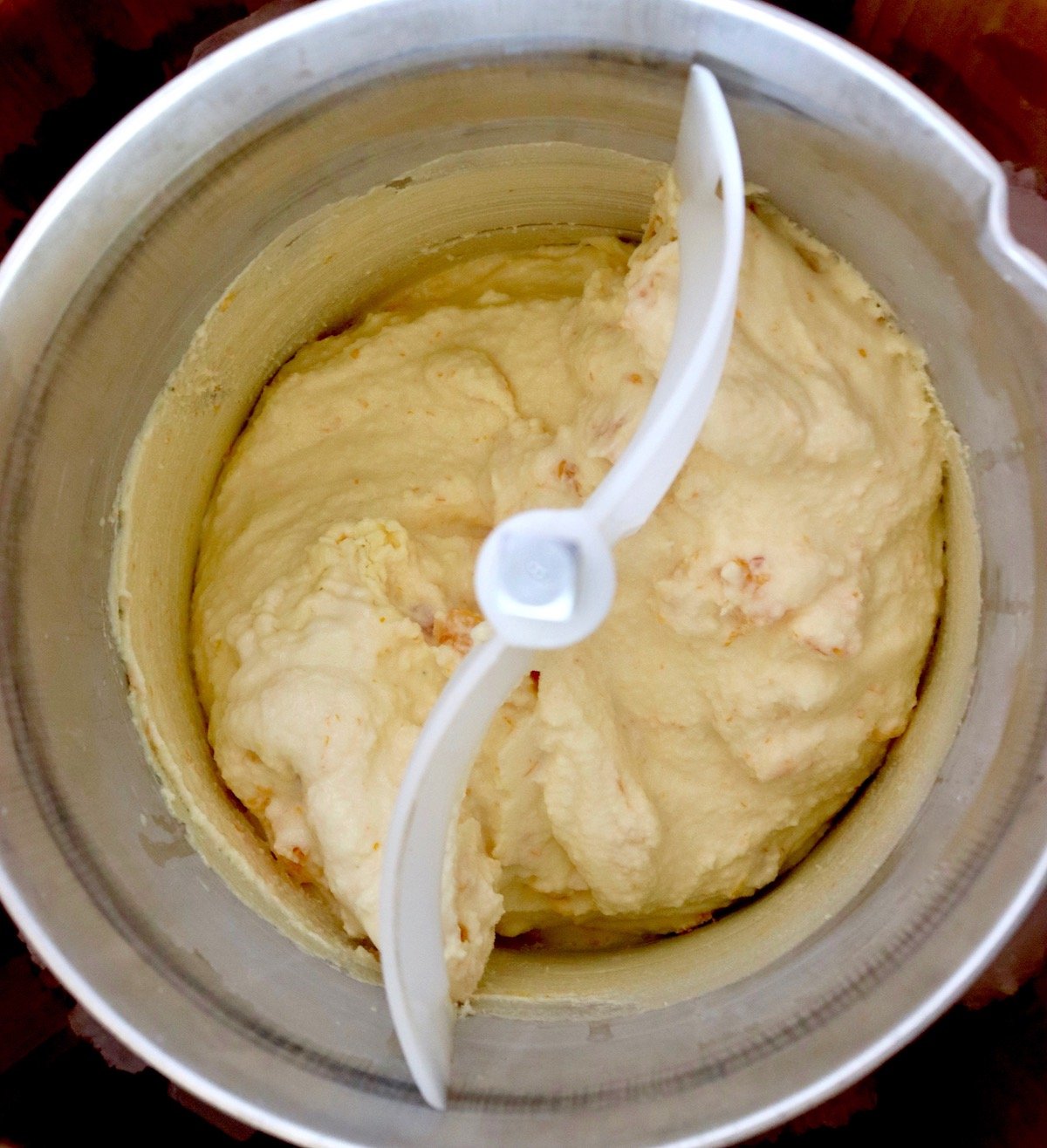 Top view of ice cream maker with churned creamsicle ice cream.