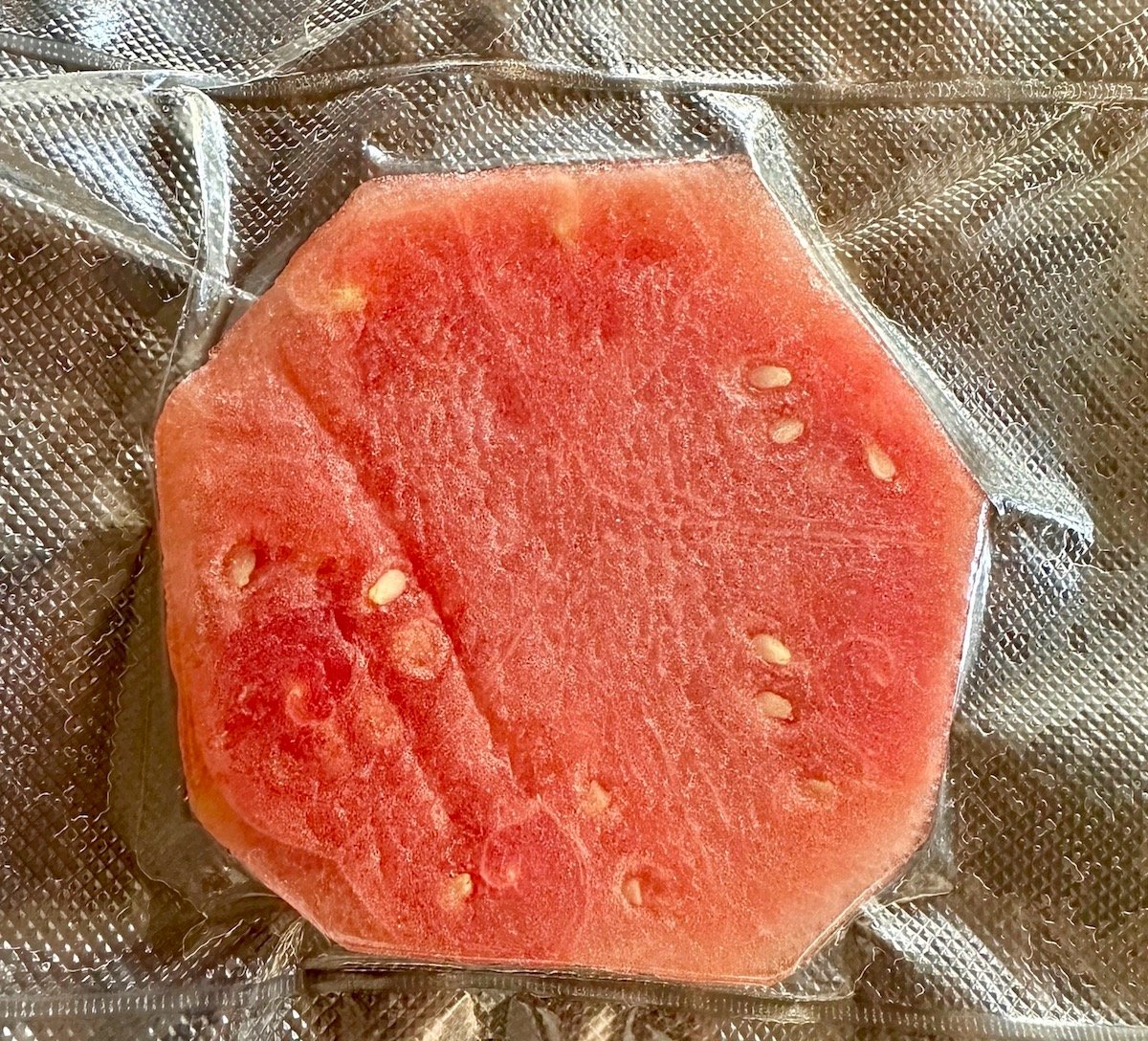 Round sliced of watermelon in a vacuum sealed bag.