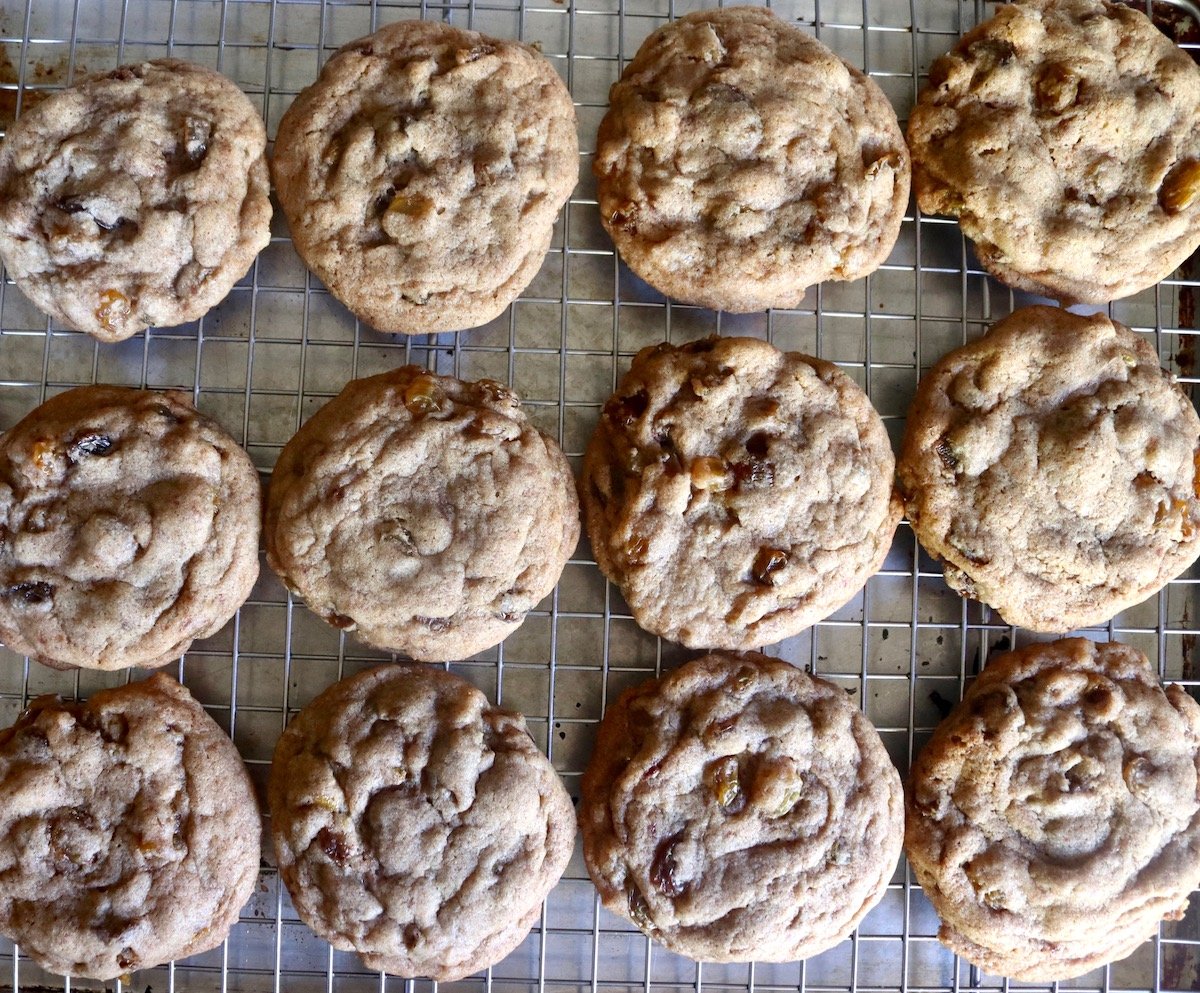 12 baked cinnamon raisin cookies on a cooling rack.