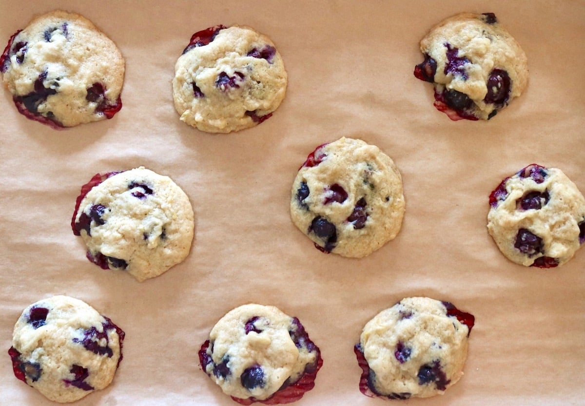 9 Baked Blueberry-Lemon Cookies on a parchment-lined baking sheet.