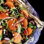 Close up of Persimmon salad on blue and white china platter