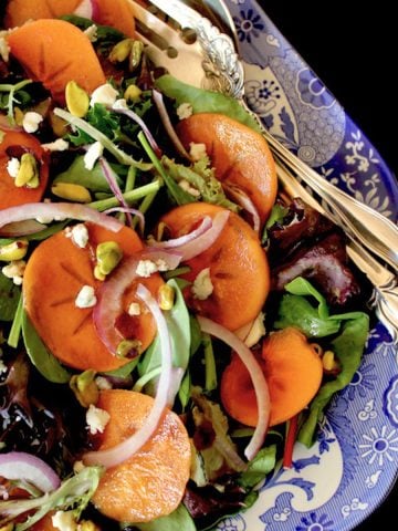 Close up of Persimmon salad on blue and white china platter