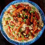 of roasted carrot sticks and cauliflower florets with chopped green onions.