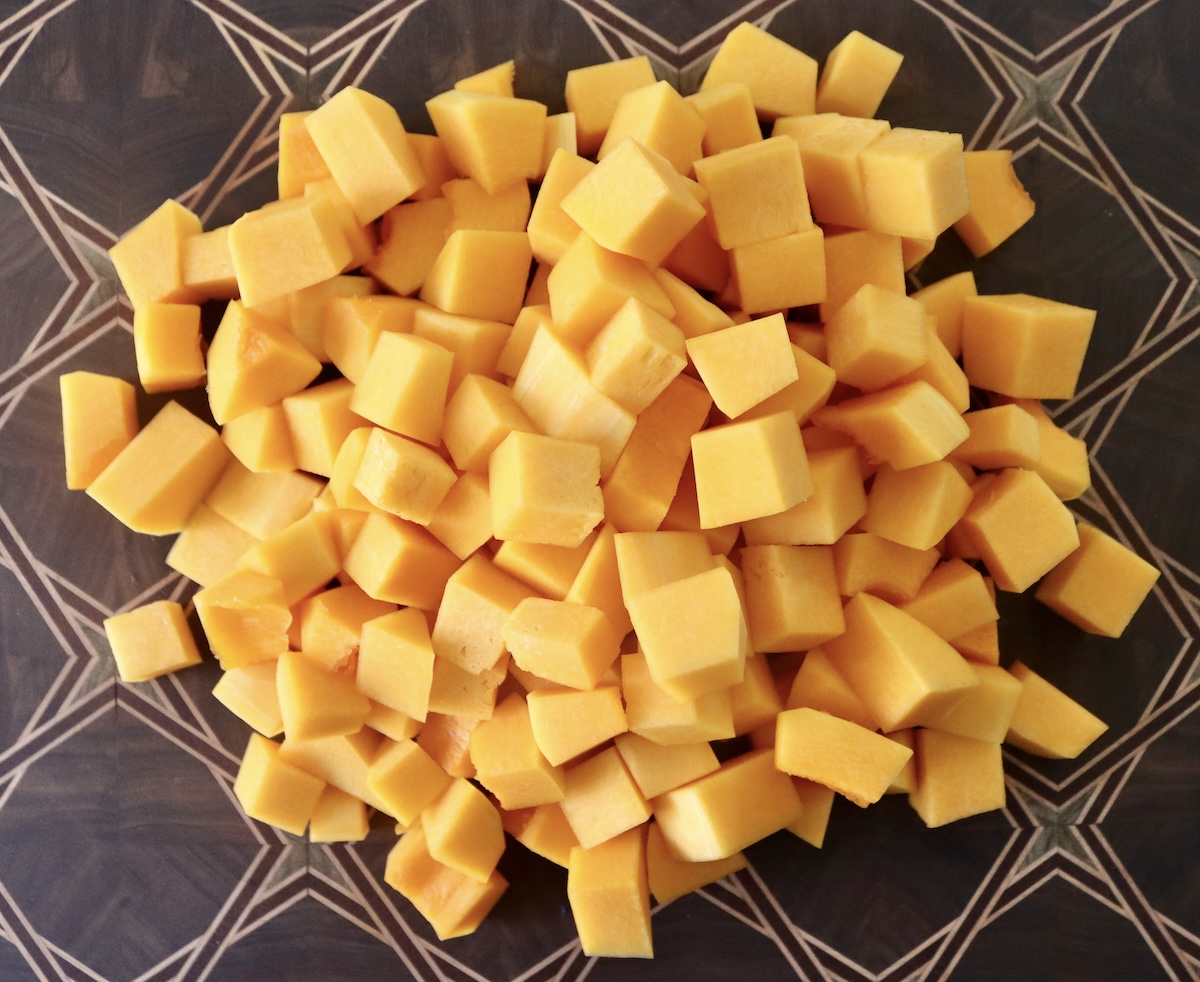 Pile of cubed, raw butternut squash.