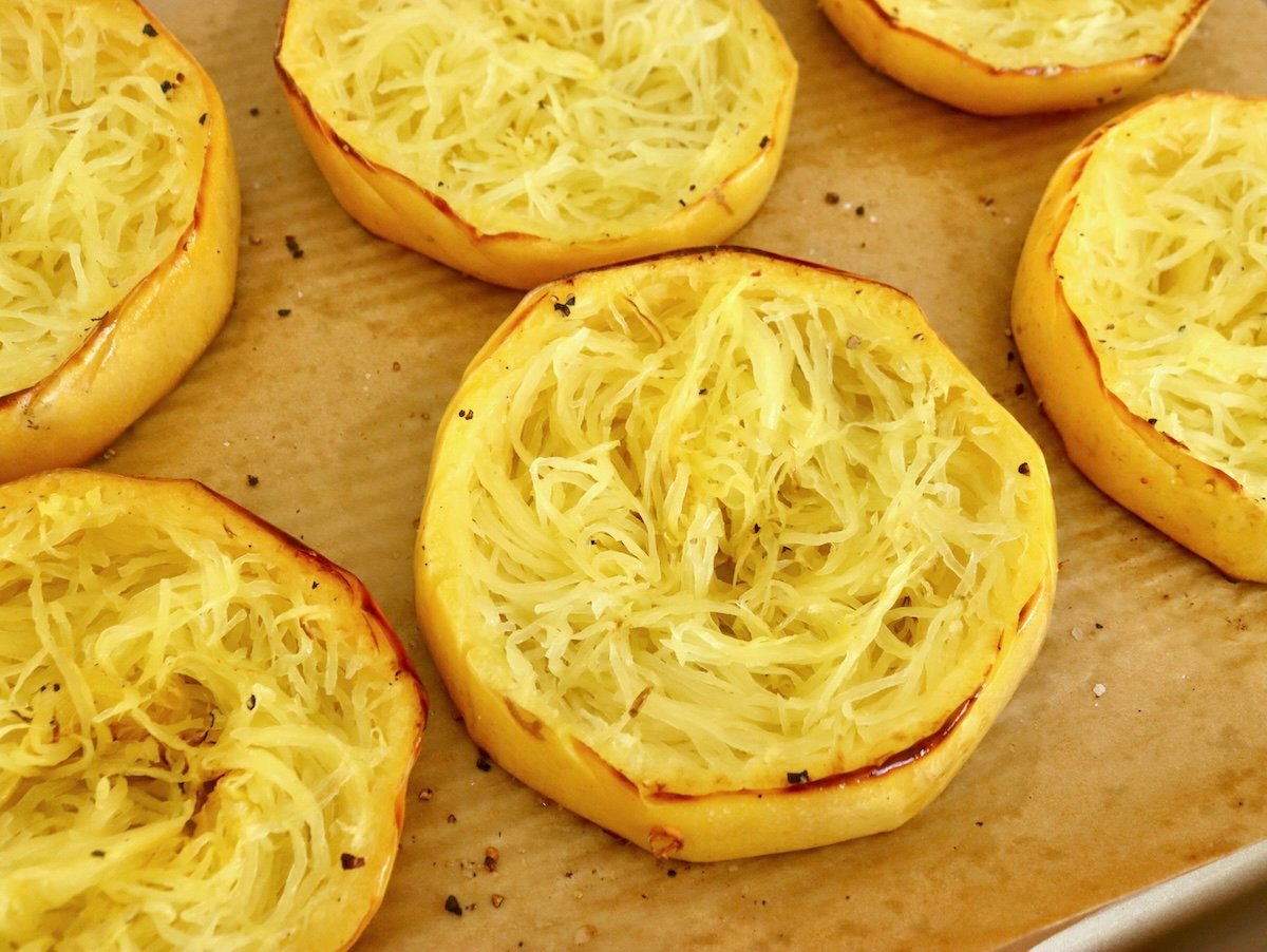 Spaghetti-Squash-Rings-with-Feta-and-Olives Spaghetti squash rings on parchment-lined baking sheet.
