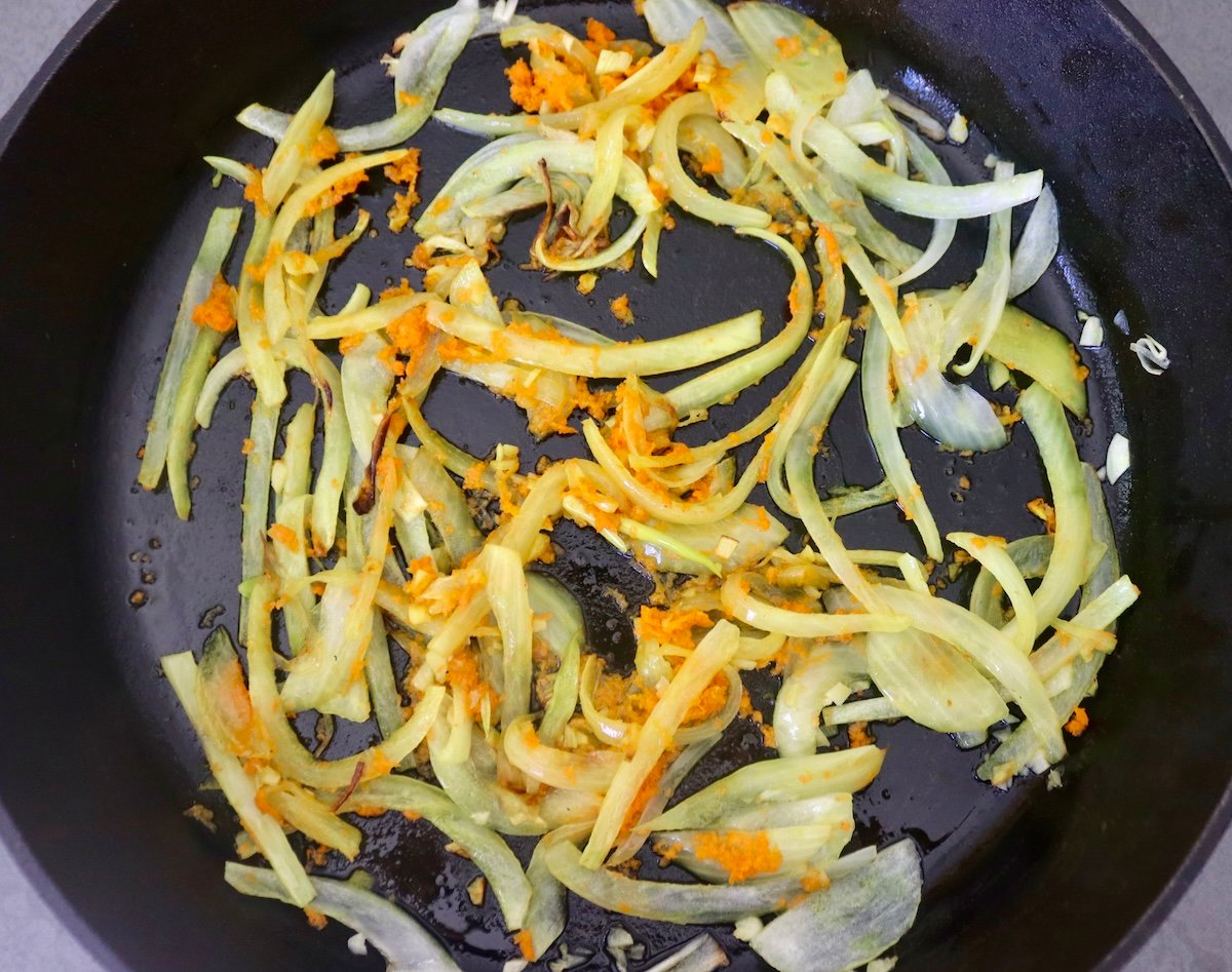 Baked-Red-Snapper-Recipe Large cast iron skillet with sautéed onion and fresh grated turmeric.