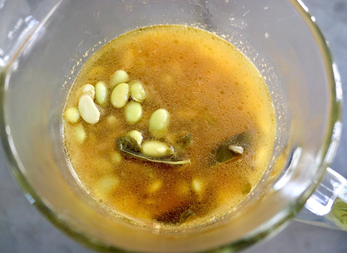 Edamame-Soup-Recipe Top vie of blender with cooked edamame soup before it's blended.