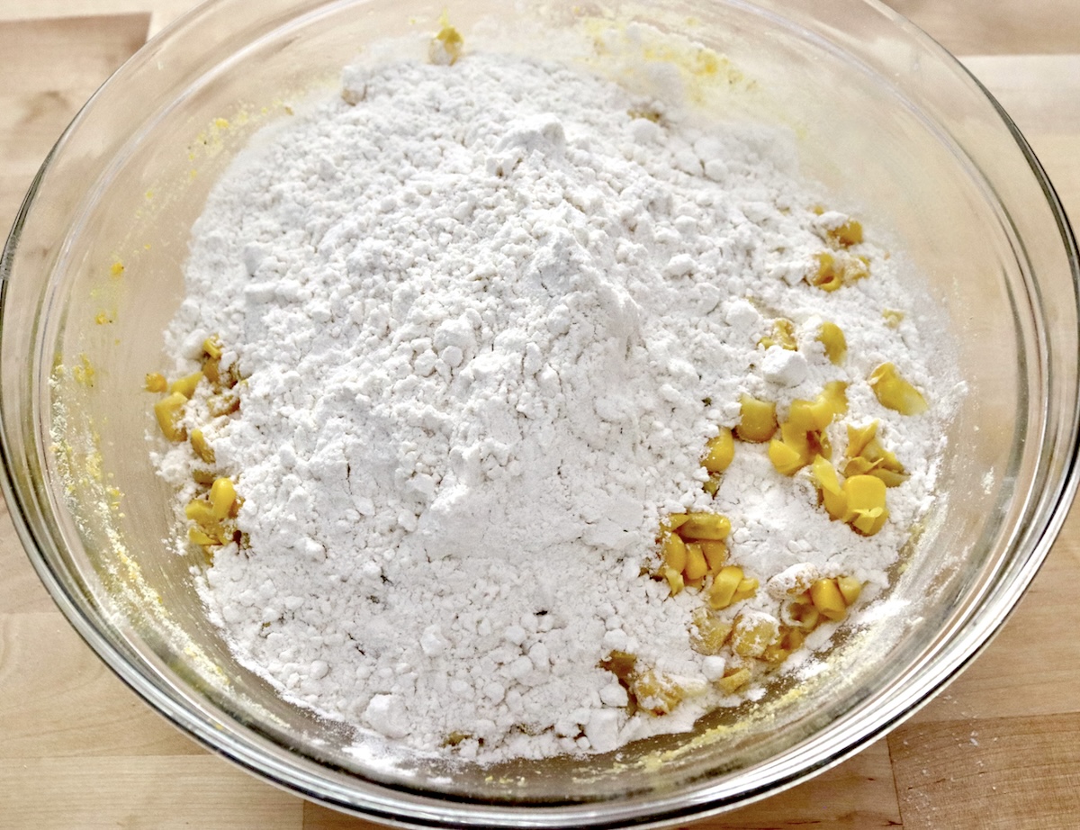 Cornbread-Cookies-Recipe Glass bowl with flour and corn kernels.