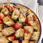 Whole, round French bread loaf cut into squares, baked and filled with fresh blueberries and strawberries.