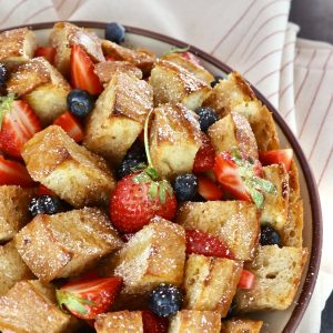 Whole, round French bread loaf cut into squares, baked and filled with fresh blueberries and strawberries.