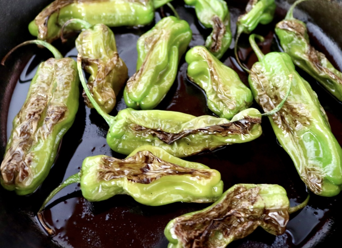 Shishito-Pepper-Salsa-Recipe Charred shishito peppers in a cast iron skillet.