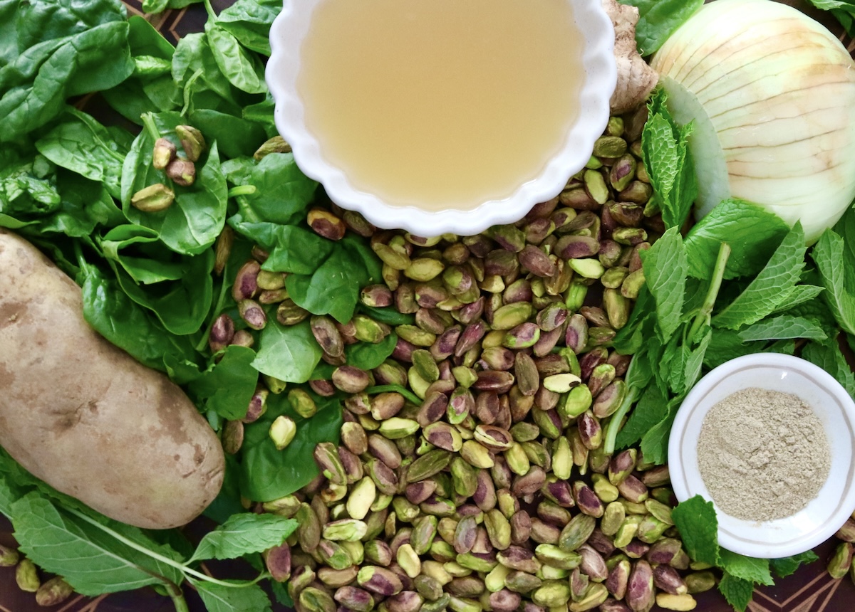 Pistachio-Soup-Recipe Ingredients for pistachio soup including shelled pistachios, spinach, mint, potato, onion, chicken stock and cardamom.