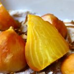 Salt-roasted golden beets, with one large one sliced in half.