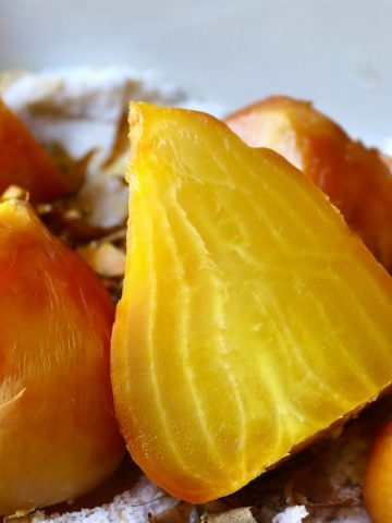 Salt-roasted golden beets, with one large one sliced in half.